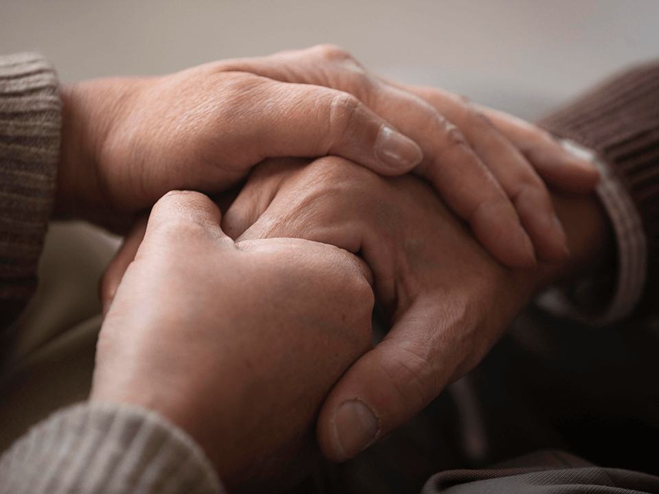 Mourning-hands-holding-losss-bereavement-funeral-prayers-consoles-tallon-mortuary